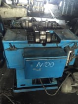 Blue N 100 industrial manufacturing machine with exposed rollers and complex mechanical components.