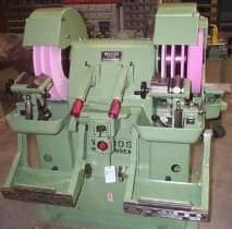 Green MAHO 105 industrial grinding machine with two vertical and two horizontal grinding wheels, featuring tool holding fixtures on both sides.