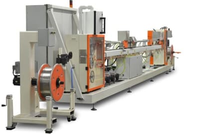 Industrial wire processing line with an unwinder spool on the left, leading to multiple inline stations for continuous material handling and production.