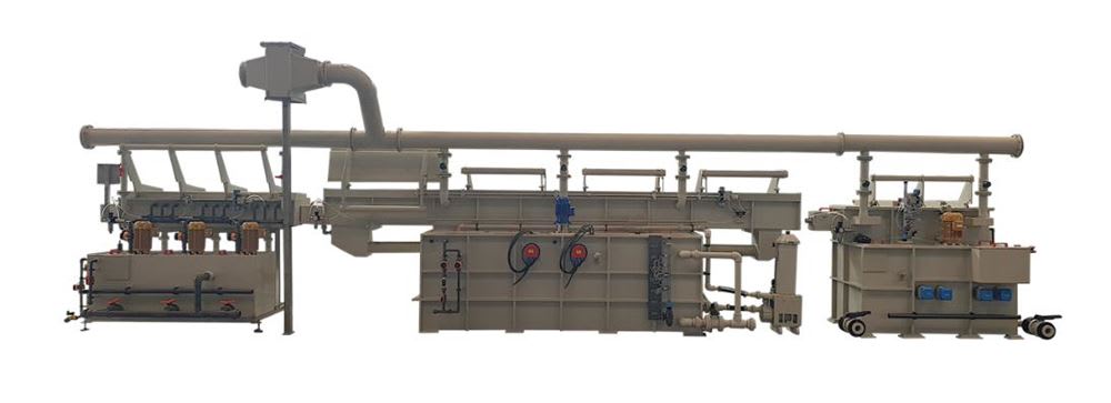Industrial multi-stage chemical processing line featuring interconnected tanks, pumps, and extensive piping.