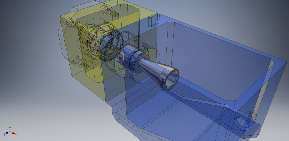 Modelo CAD 3D de un ensamblaje mecánico con vista transparente, mostrando una boquilla cónica metálica que conecta una carcasa amarilla y un alojamiento azul.