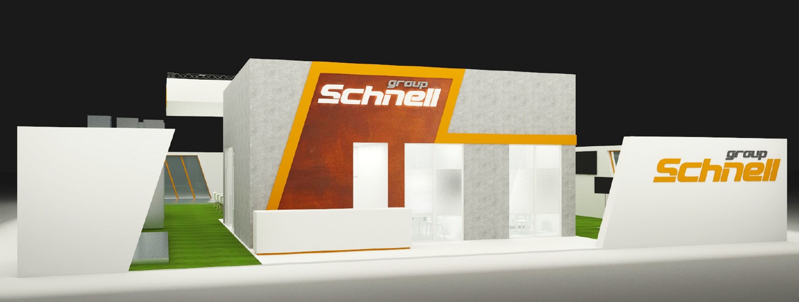 Modern exhibition stand for group Schnell featuring a grey textured facade, orange branding lines, a reception desk, and large frosted glass windows, with green flooring on one side.