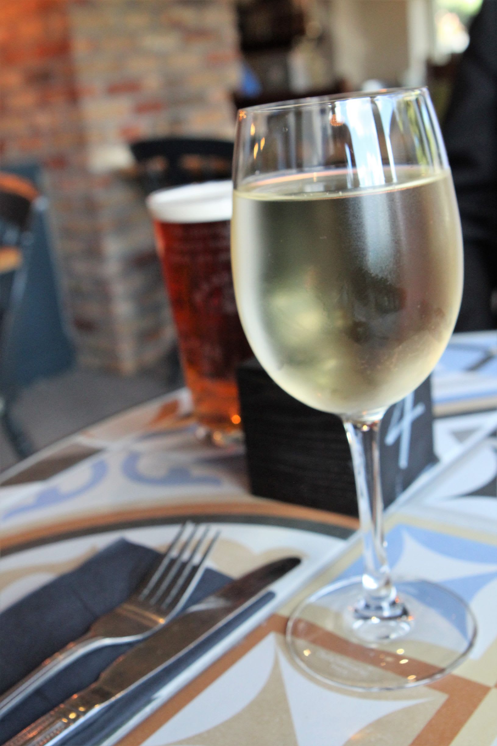 Glass of South African sauvignon blanc with a pint of Pedigree ale