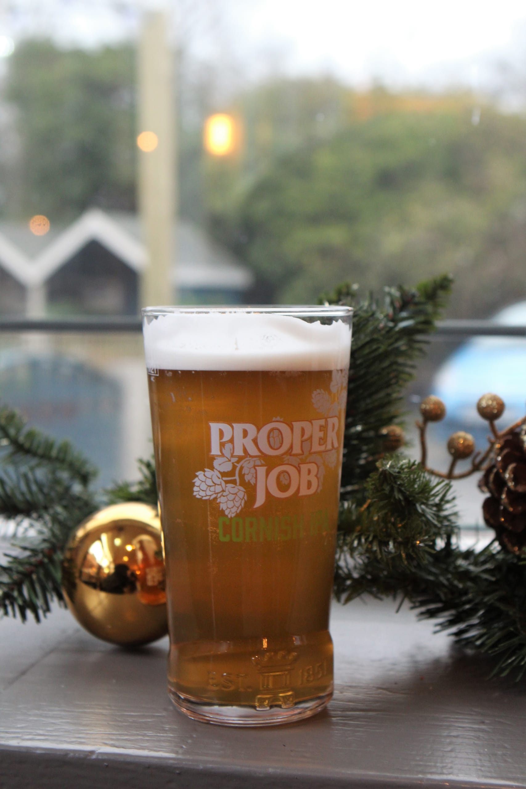 A pint of Proper Job with a Christmas bauble