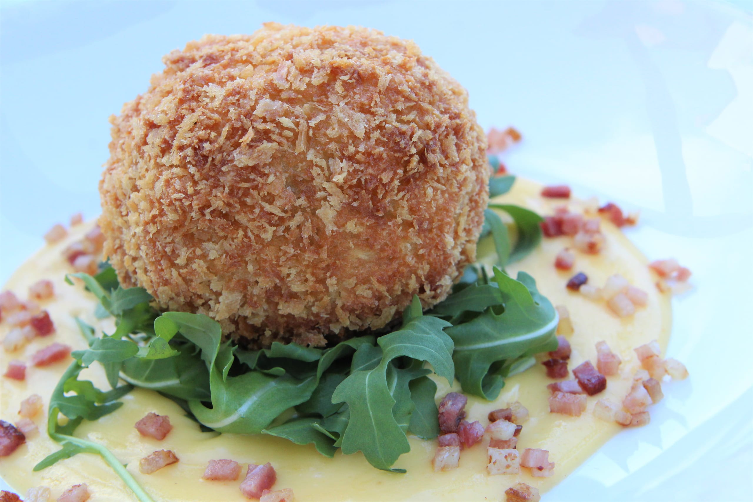 Arancini on a bed of rocket