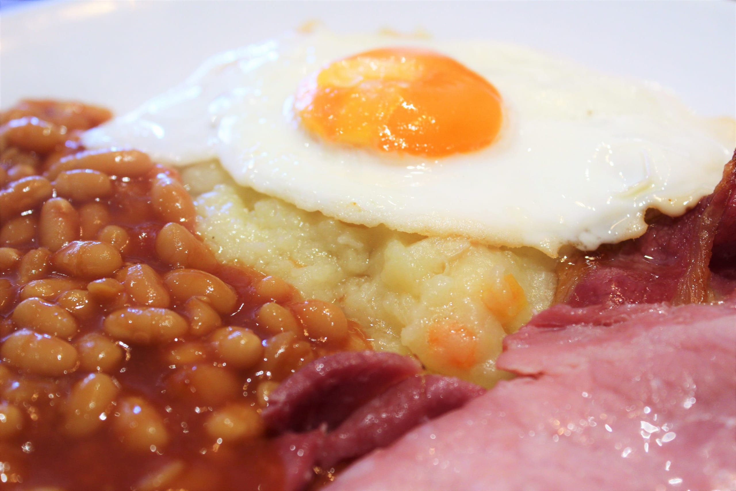 A very loose bubble and squeak served with egg, baked beans and bacon