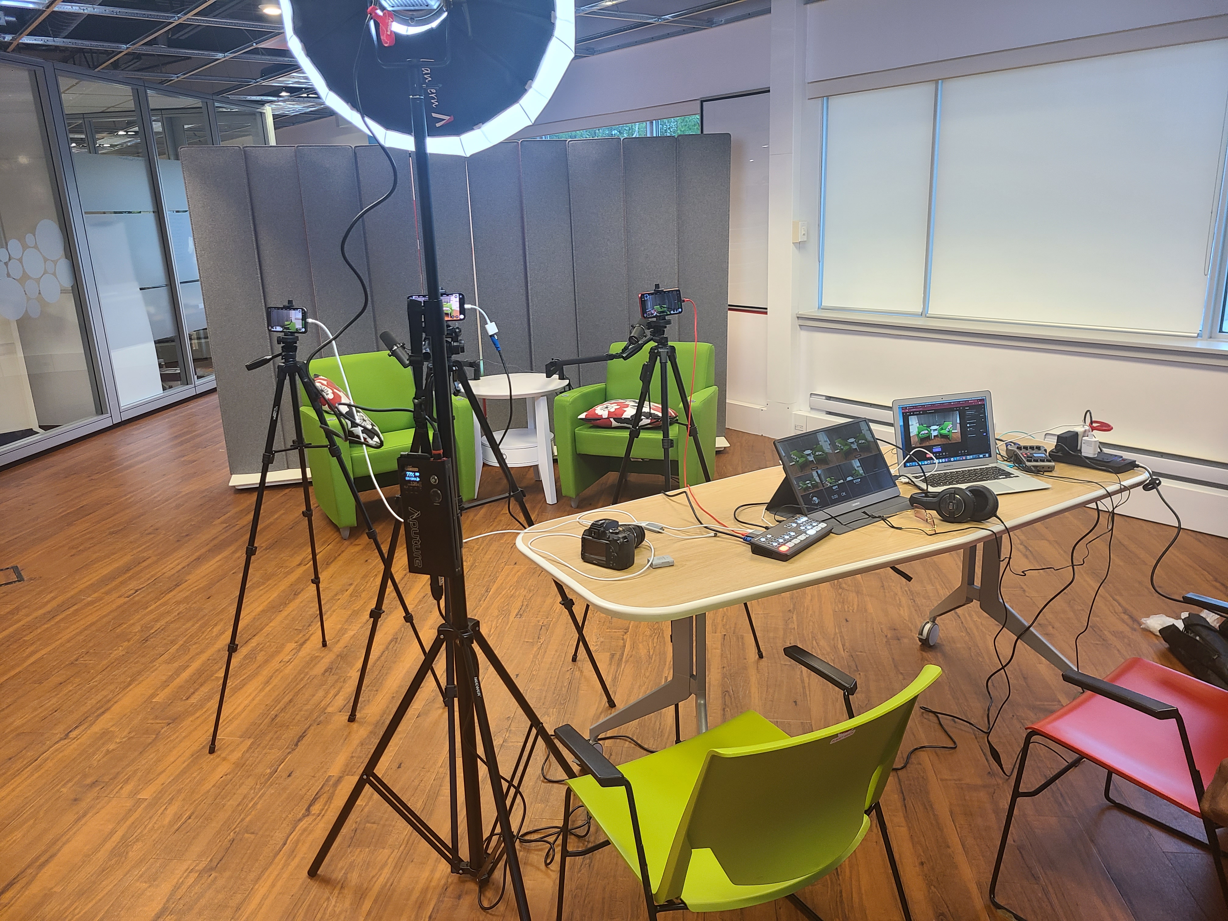 The actual StudioAnywhere multi-camera video rig — four phones on tripods, ring light, ATEM switcher and PodTrak P4 on the table