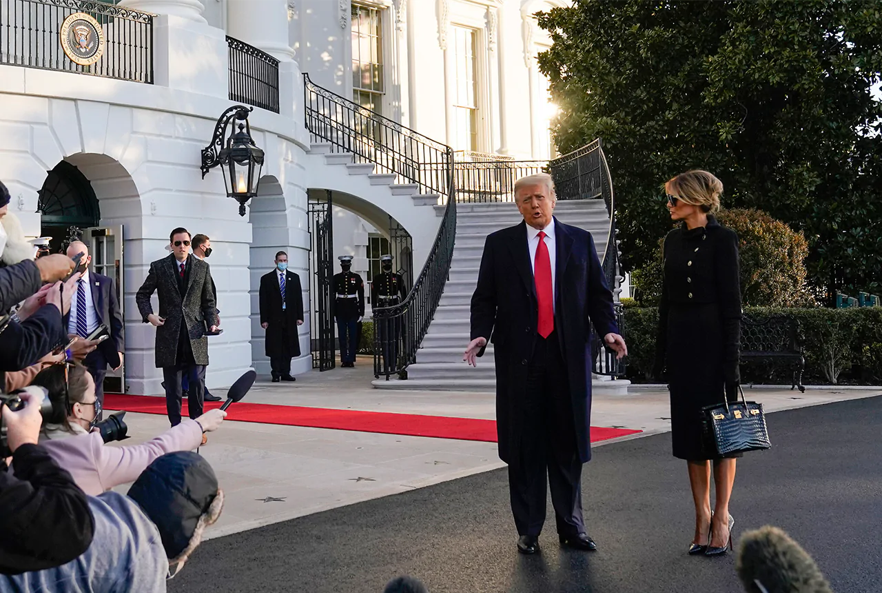 Donald Trump and his wife Melania, talk to reporters as they walk to board Marine One