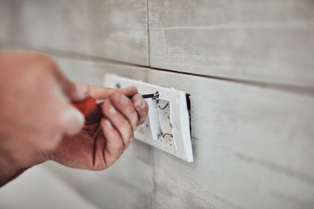 Landlord making electrical repair