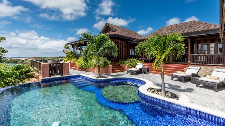 Garden lawn and suite wings of Calabash Hotel behind the sheltered bay at L'Anse aux Épines, Grenada