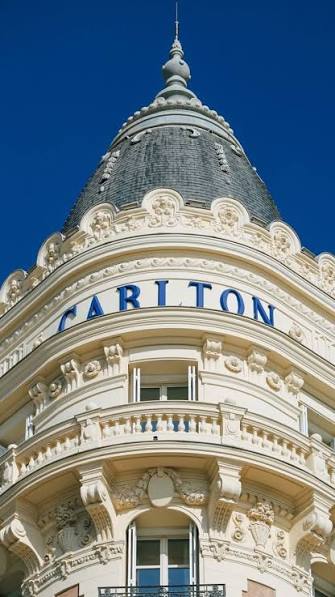White Belle Époque façade and twin cupolas of the Carlton Cannes on La Croisette