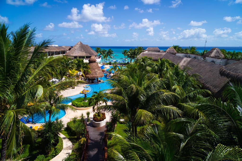 Pink colonial-style buildings of Coco Reef Resort behind its sheltered lagoon beach in Tobago