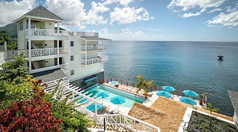 Stone ramparts and waterfront pool deck of Fort Young Hotel on Roseau's harbour, Dominica