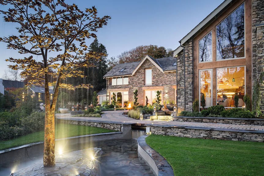 White gables of Gilpin Hotel amid gardens and Lakeland fells near Windermere