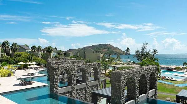 Stone courtyards and pool of Park Hyatt St Kitts framing Nevis Peak across the water