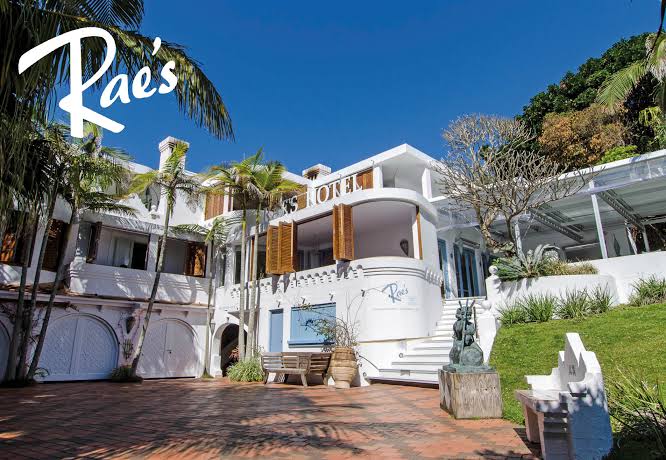 Whitewashed Mediterranean-style villa of Raes on Wategos above the palms of Wategos Beach, Byron Bay