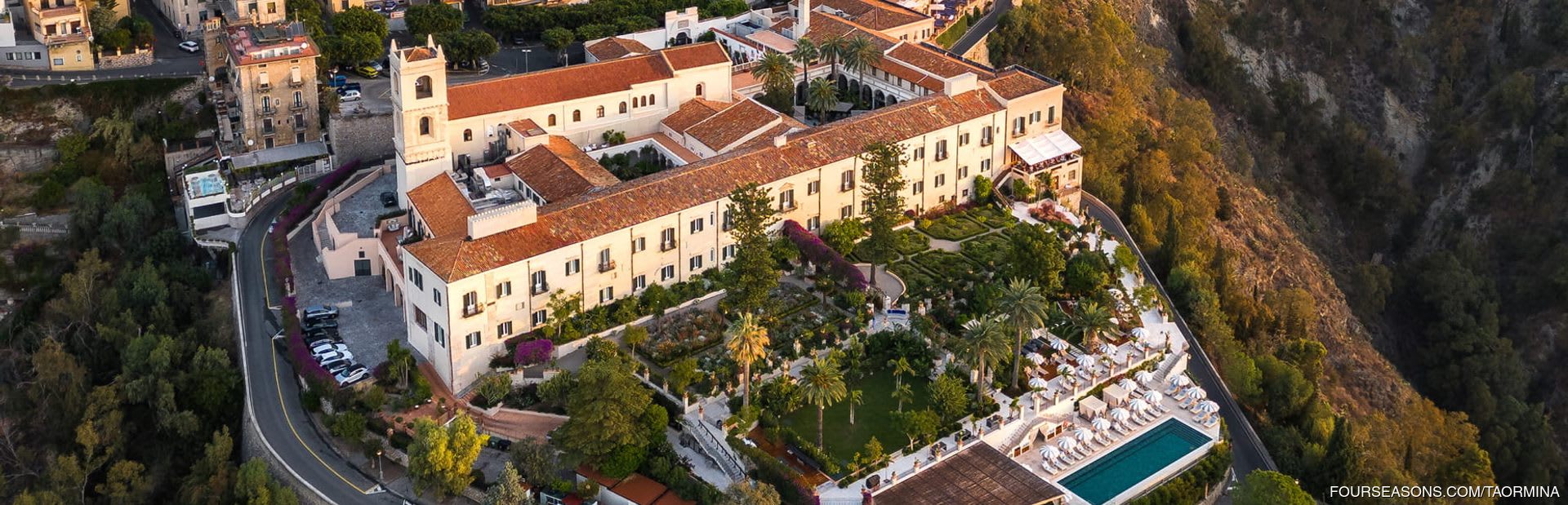 Clifftop convent buildings and gardens of San Domenico Palace above the sea at Taormina