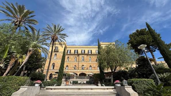Art Nouveau façade and gardens of Villa Igiea above its harbour in Palermo