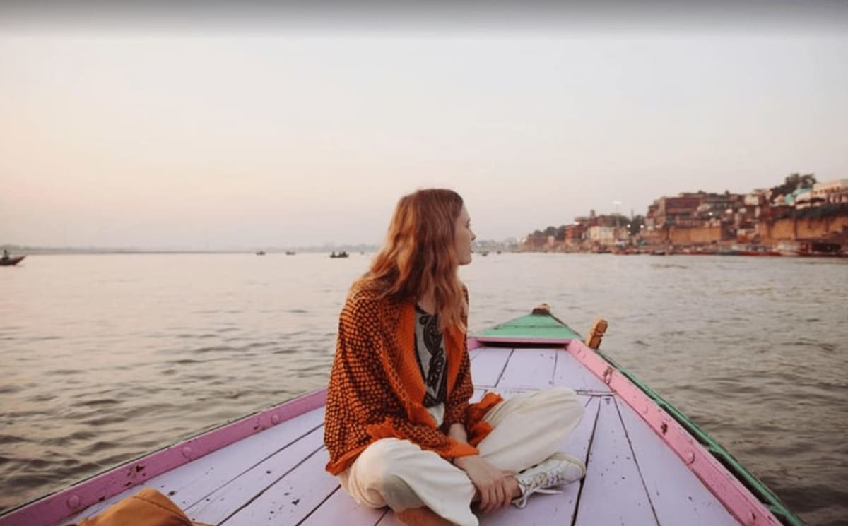 Solo female traveller walking through the historic streets near Varanasi ghats