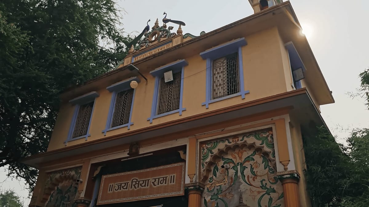 Devotees gathering in the peaceful green courtyard of Shri Sankat Mochan Hanuman Temple