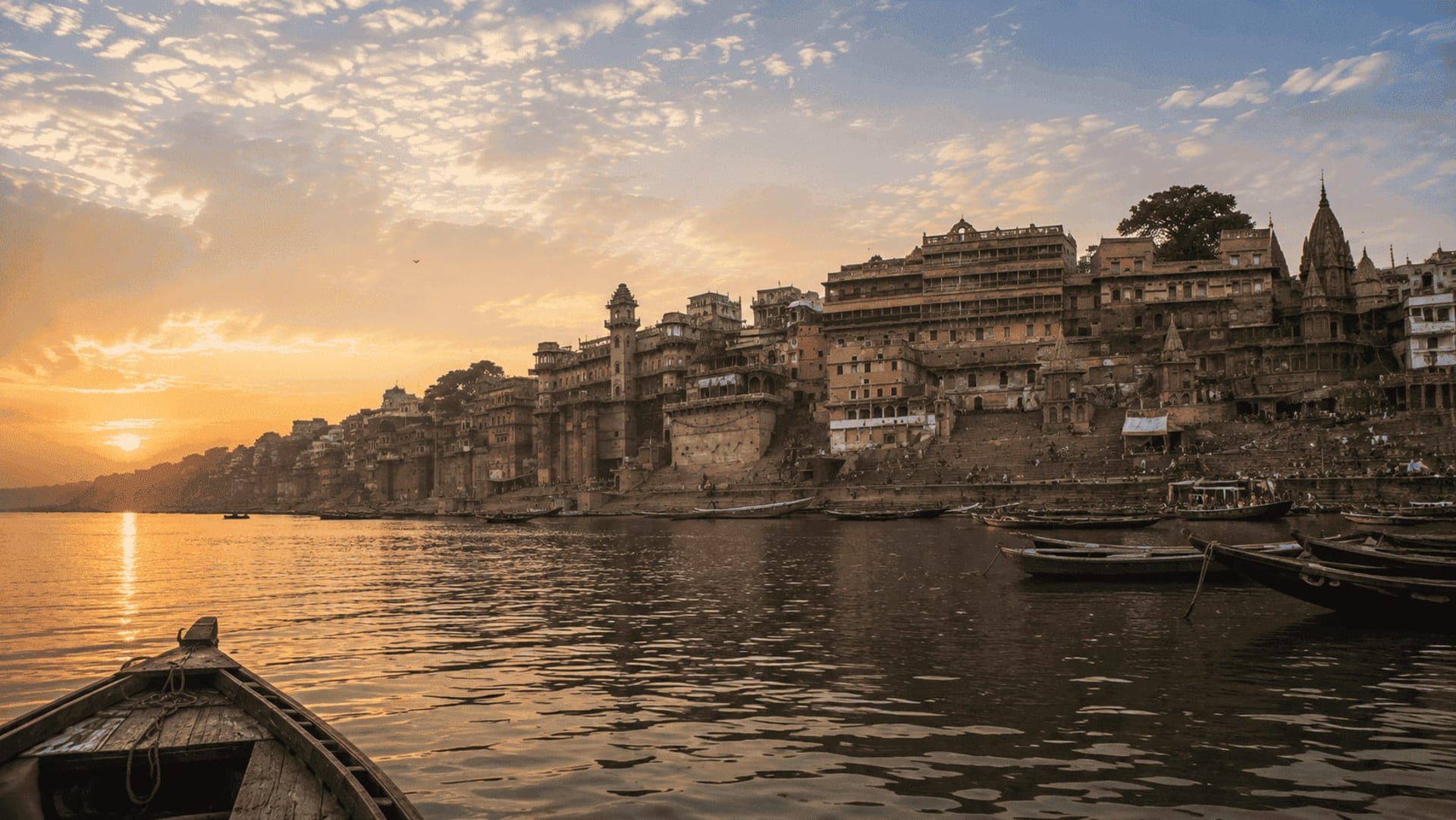 Atmospheric sunset panoramic view of Varanasi riverfront ghats and Ganges river