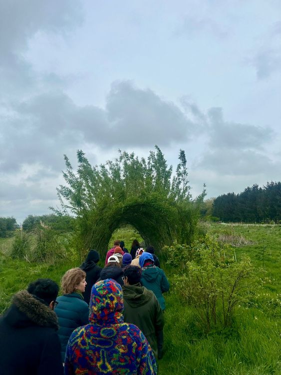 Choir members on the Spring Thing outing at Sadeh Farm, getting a guided tour of the premises with founder Talia  - March 2024