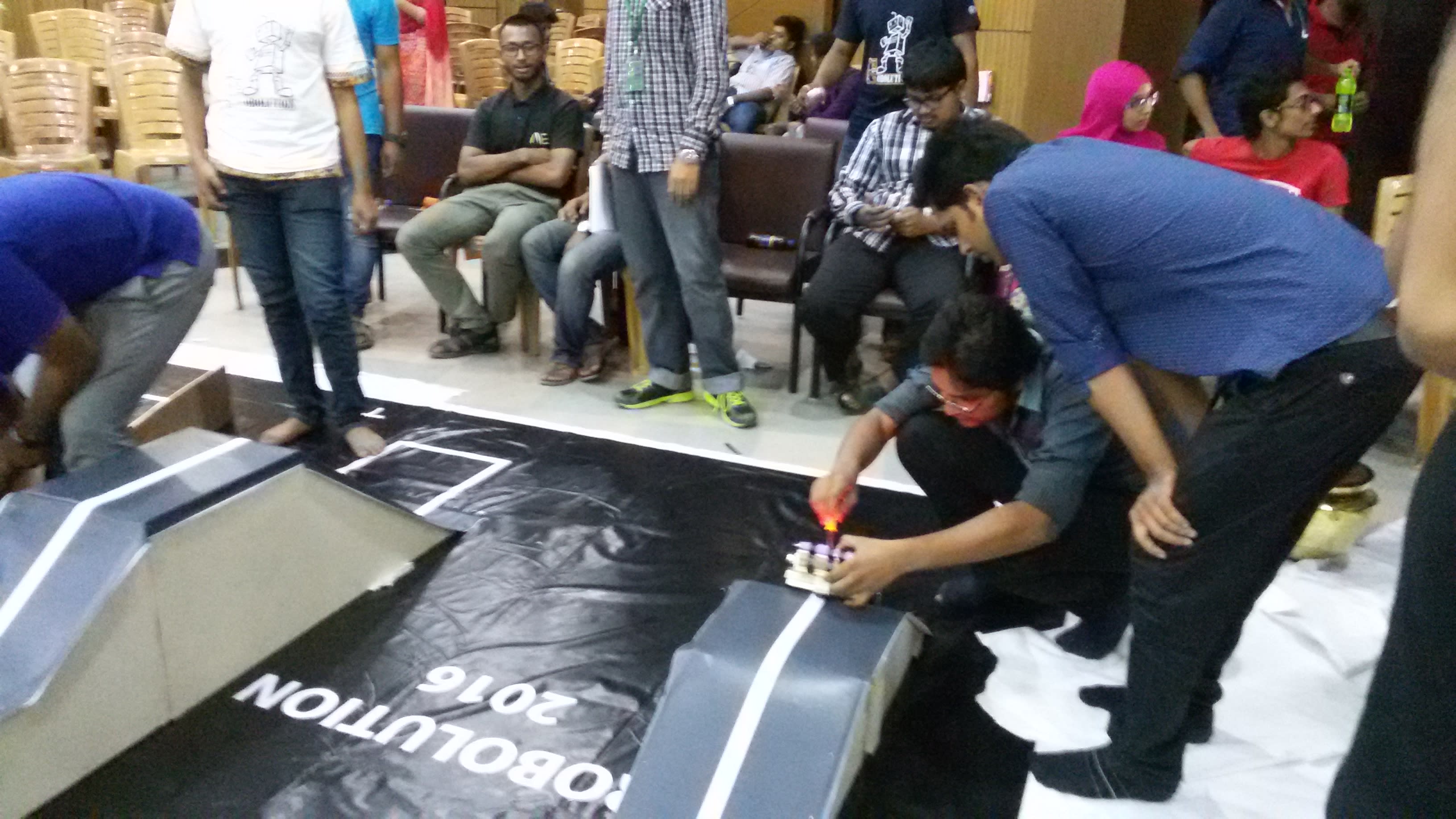 Team DUET Robo Express making final adjustments to our robot before the Line Follower Race