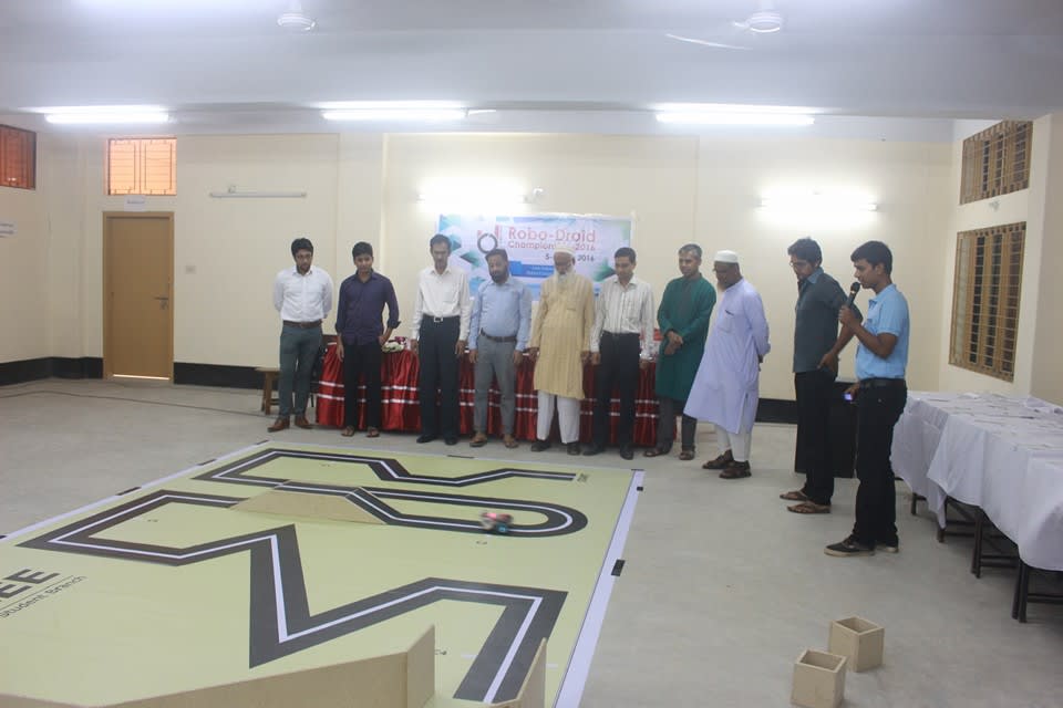 Our robot running the course as judges and guests look on at the RUET Auditorium