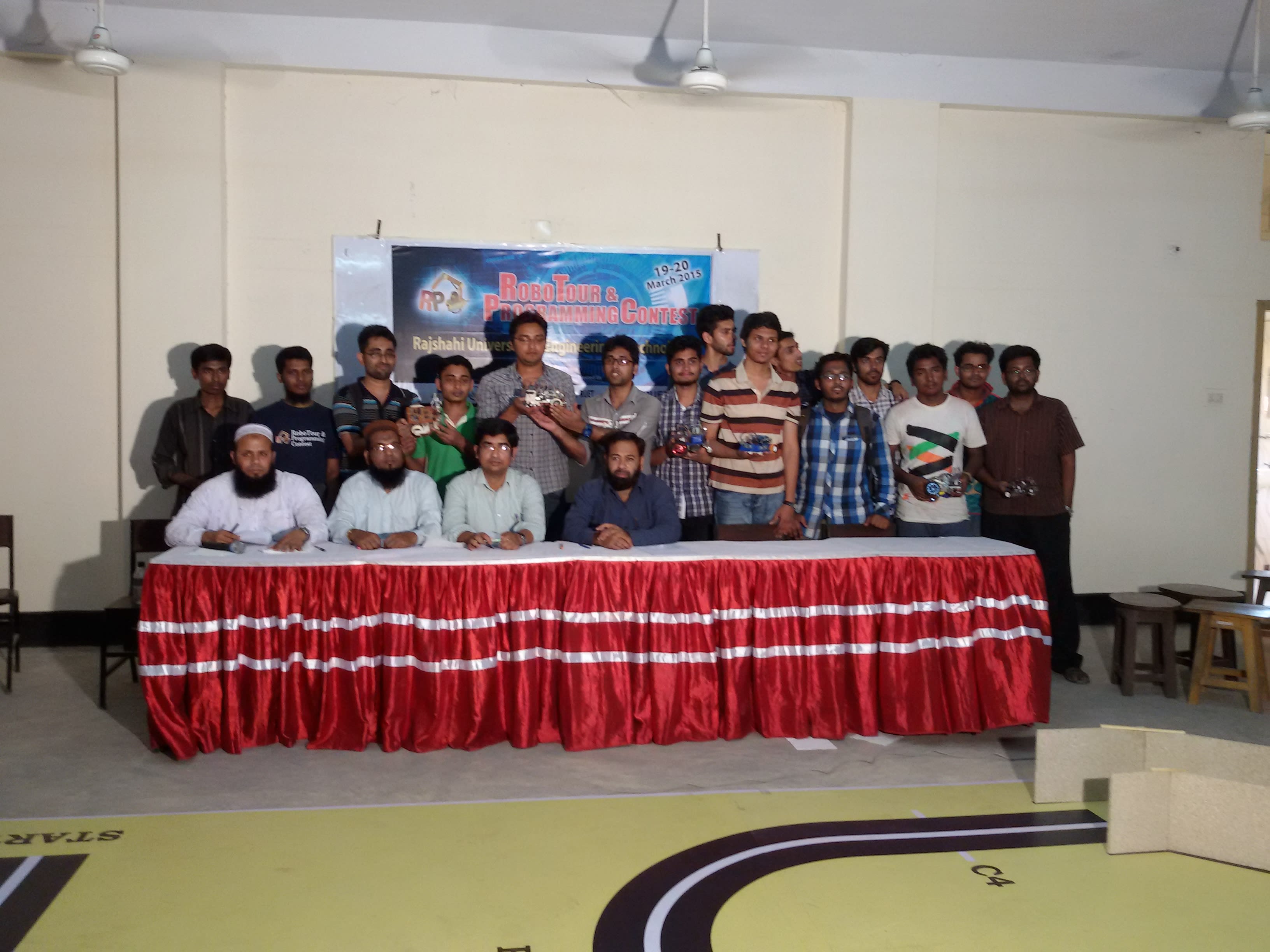 Participants with their robots and the panel of judges at RoboTour & Programming Contest 2015, RUET