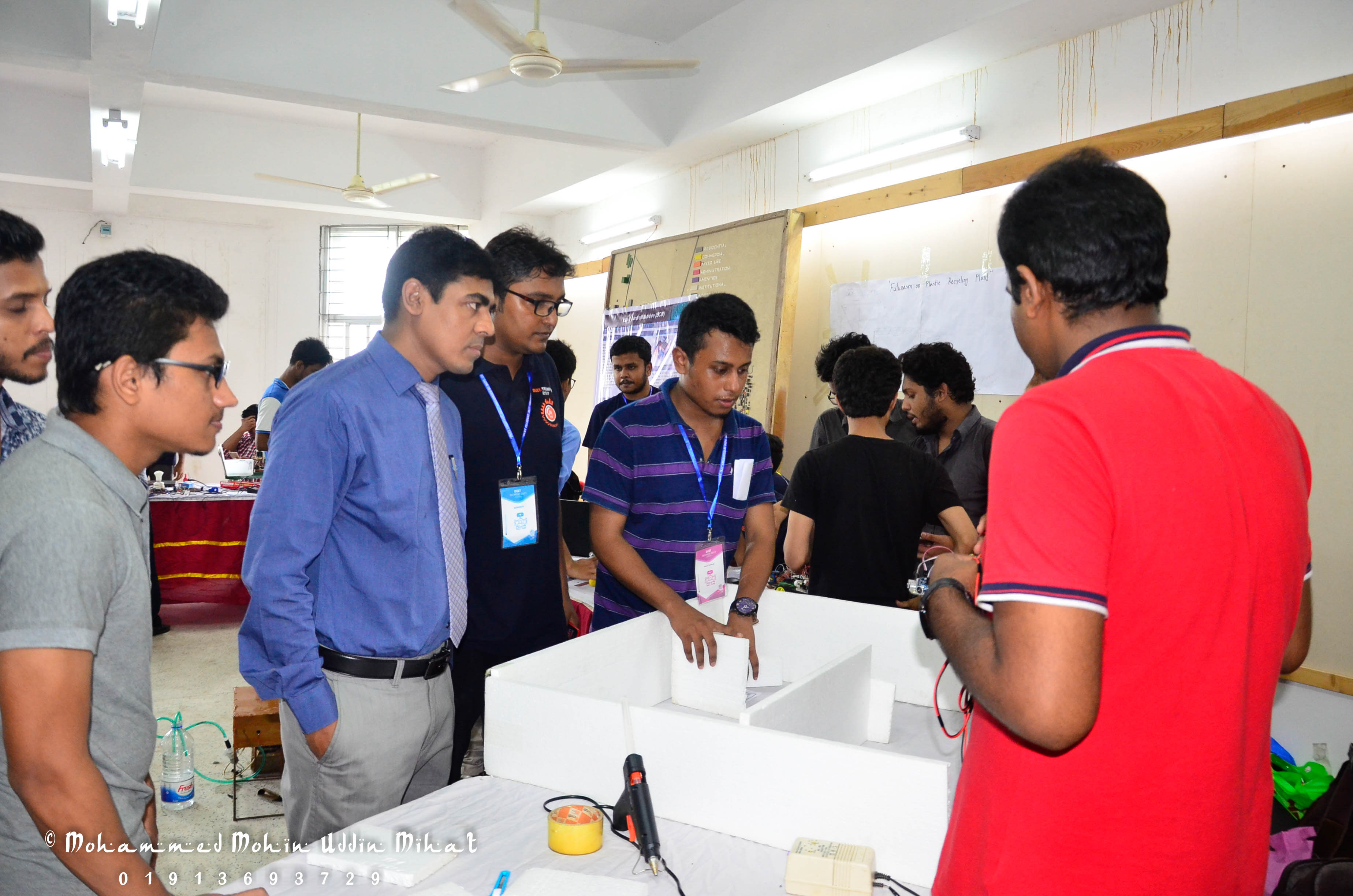 Faculty and organisers reviewing a team’s project during the DUET TECHFEST 2017 exhibition