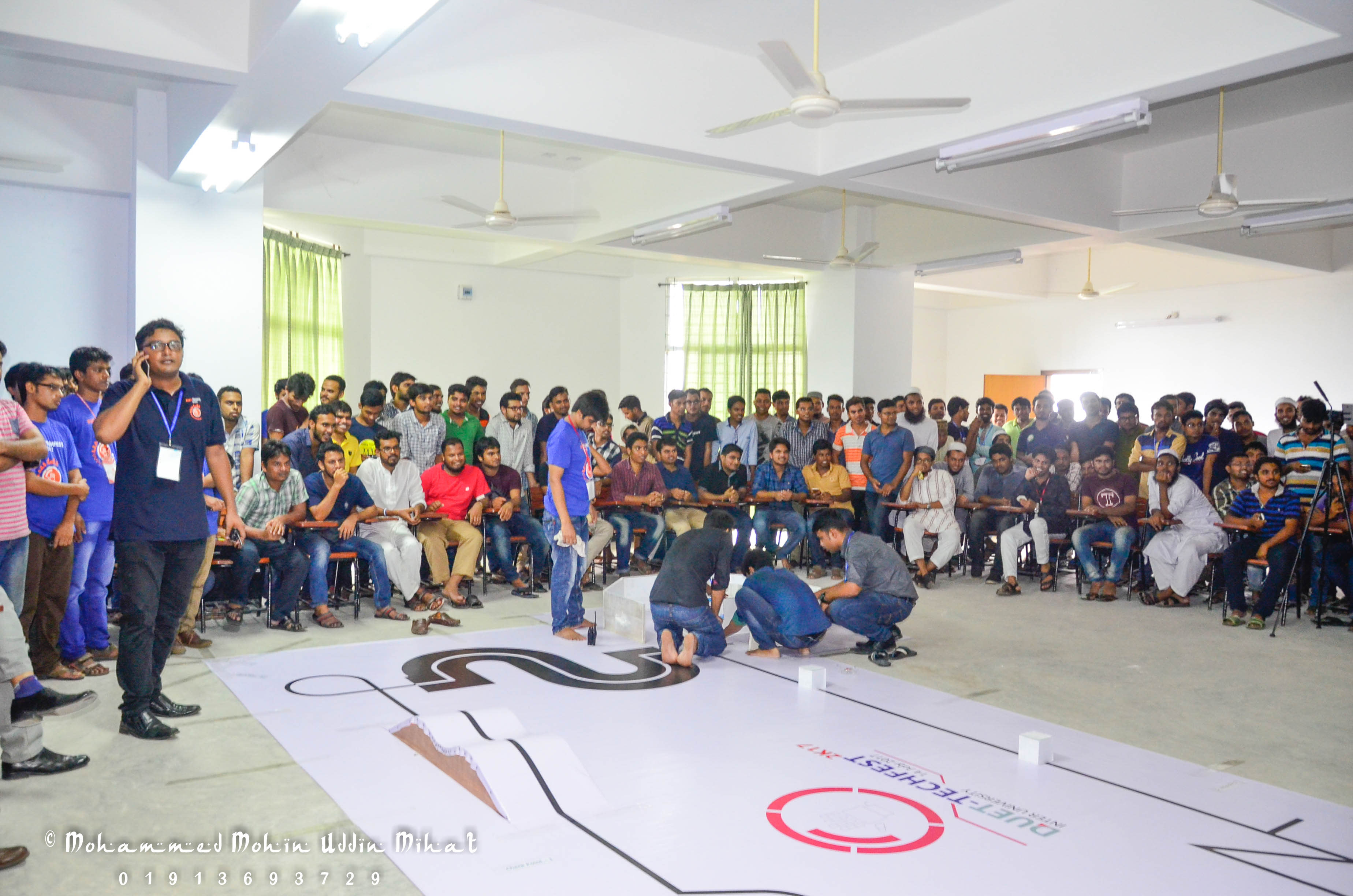 Participants and spectators gathered around the competition track as the robotics contest gets under way