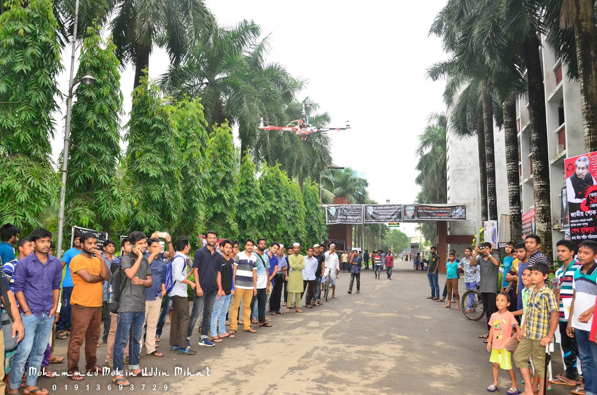 With students, teachers and visitors after the demonstration flight, alongside a commercial camera drone.