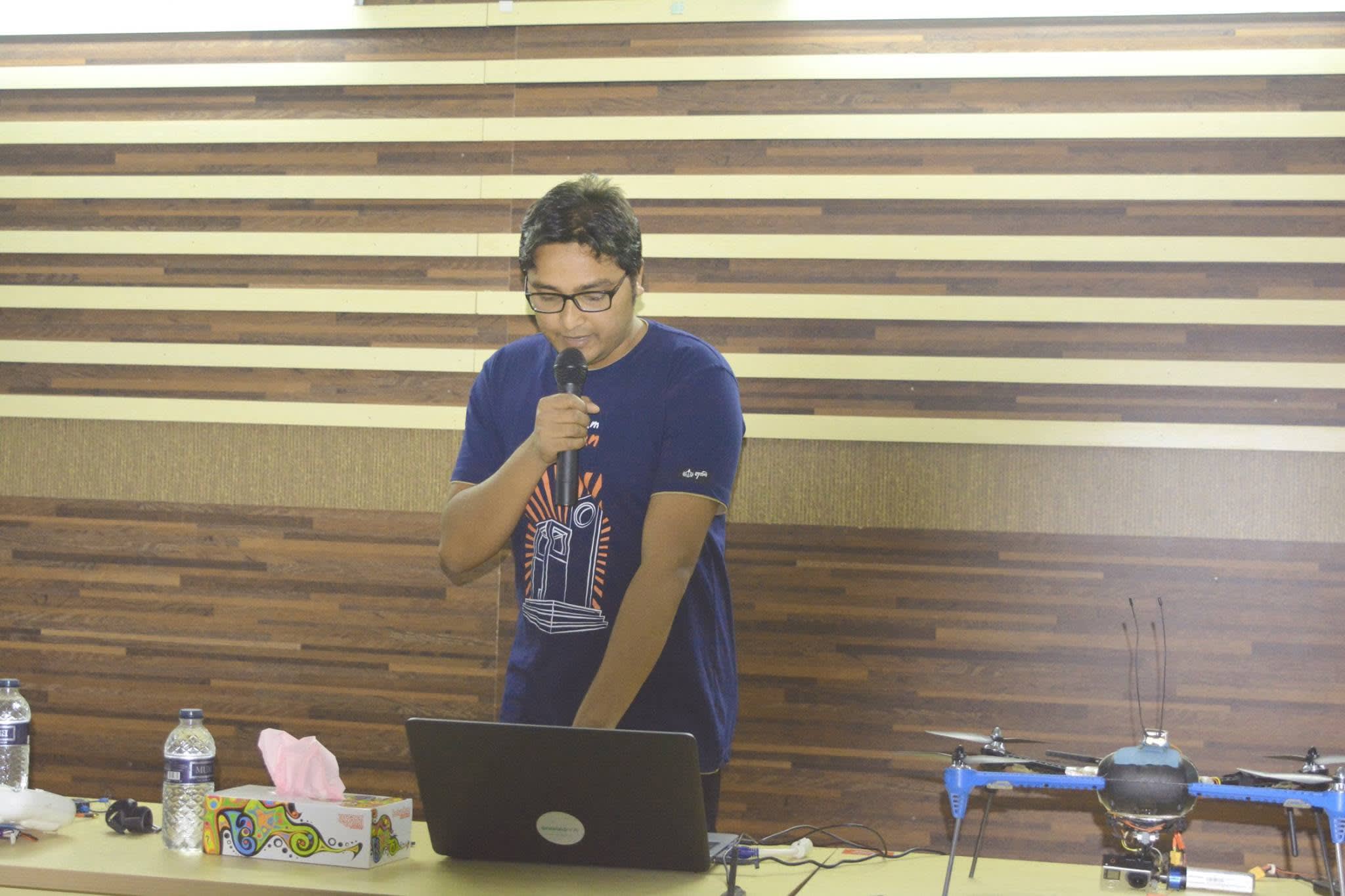 Explaining how a drone is built and controlled, with a camera drone on the table