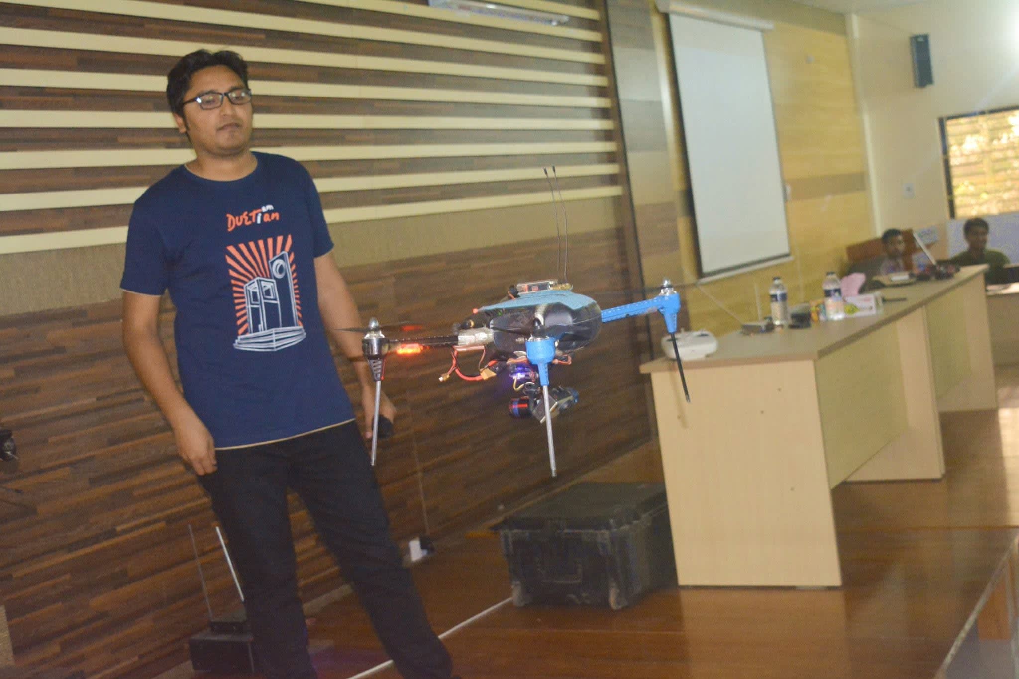 Demonstrating a camera drone in flight inside the seminar hall