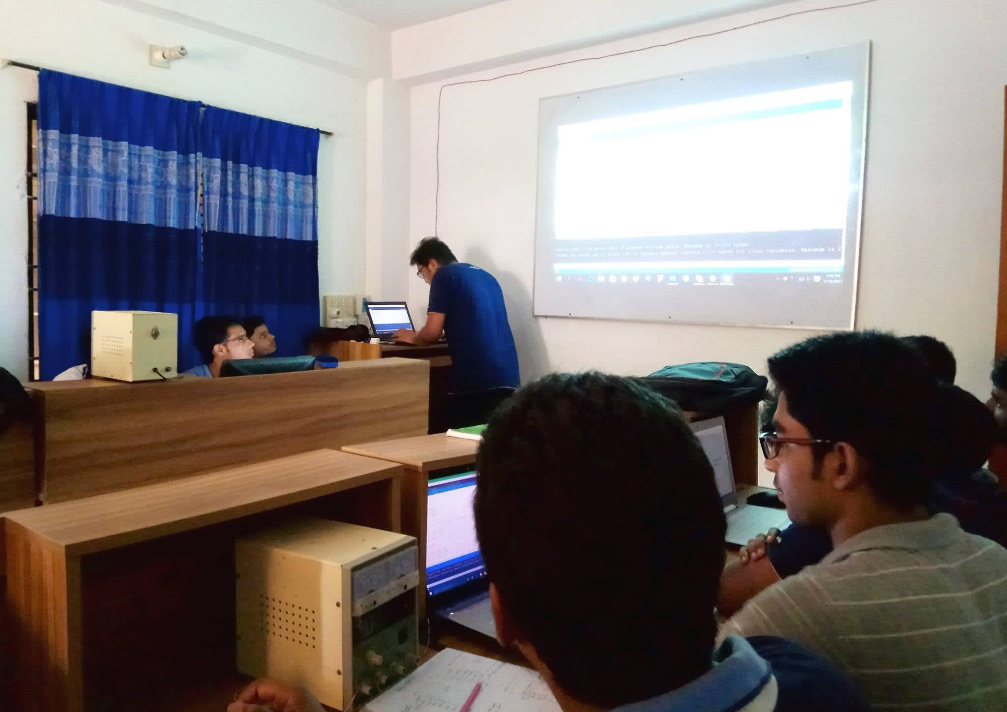 Writing and compiling Arduino code for the robot, shown on the projector