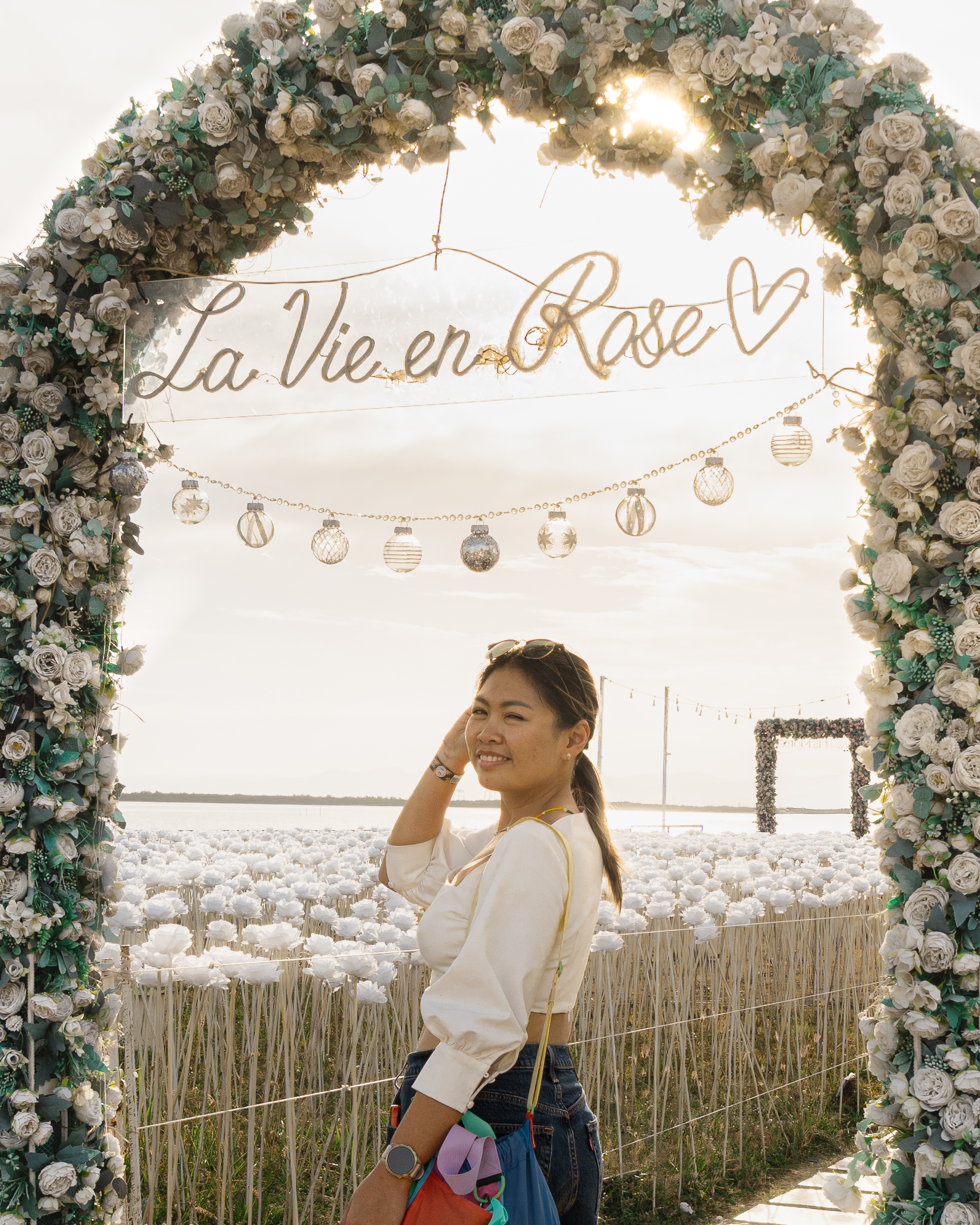 Standing under the La Vie en Rose floral arch at 10000 Roses Cafe in Cordova Cebu