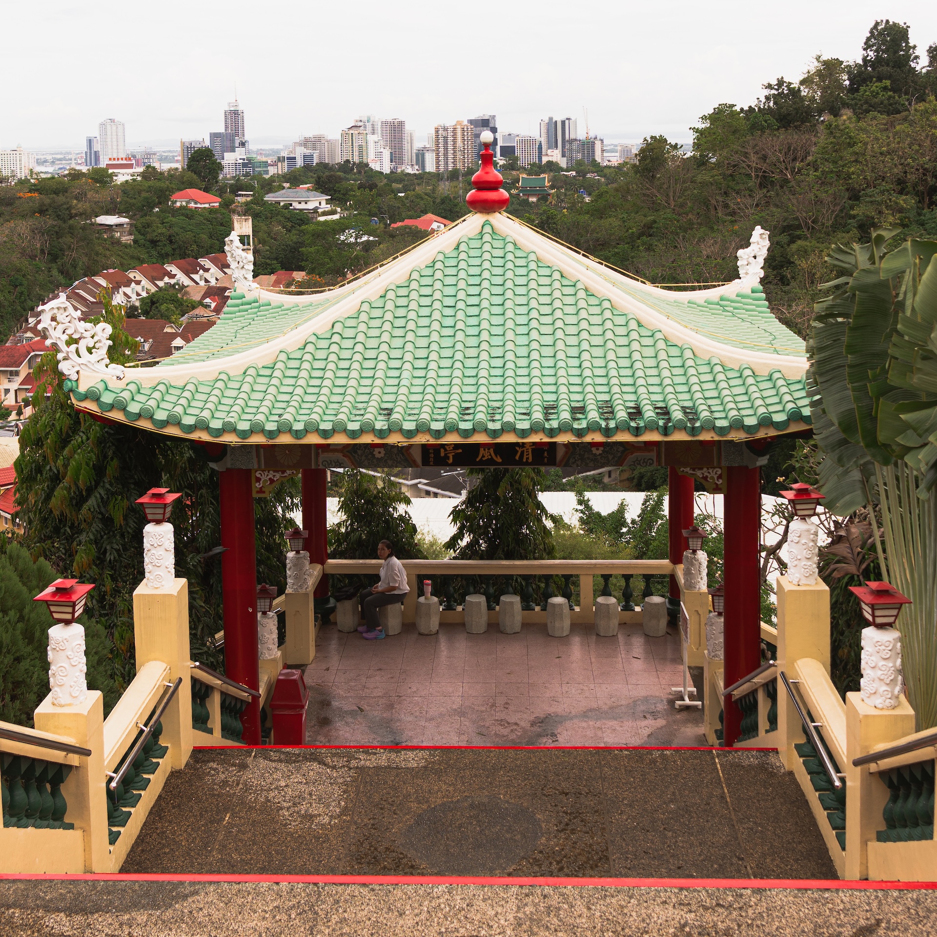 Chinese pagoda gazebo at the Taoist Temple in Beverly Hills Cebu with city skyline in the background