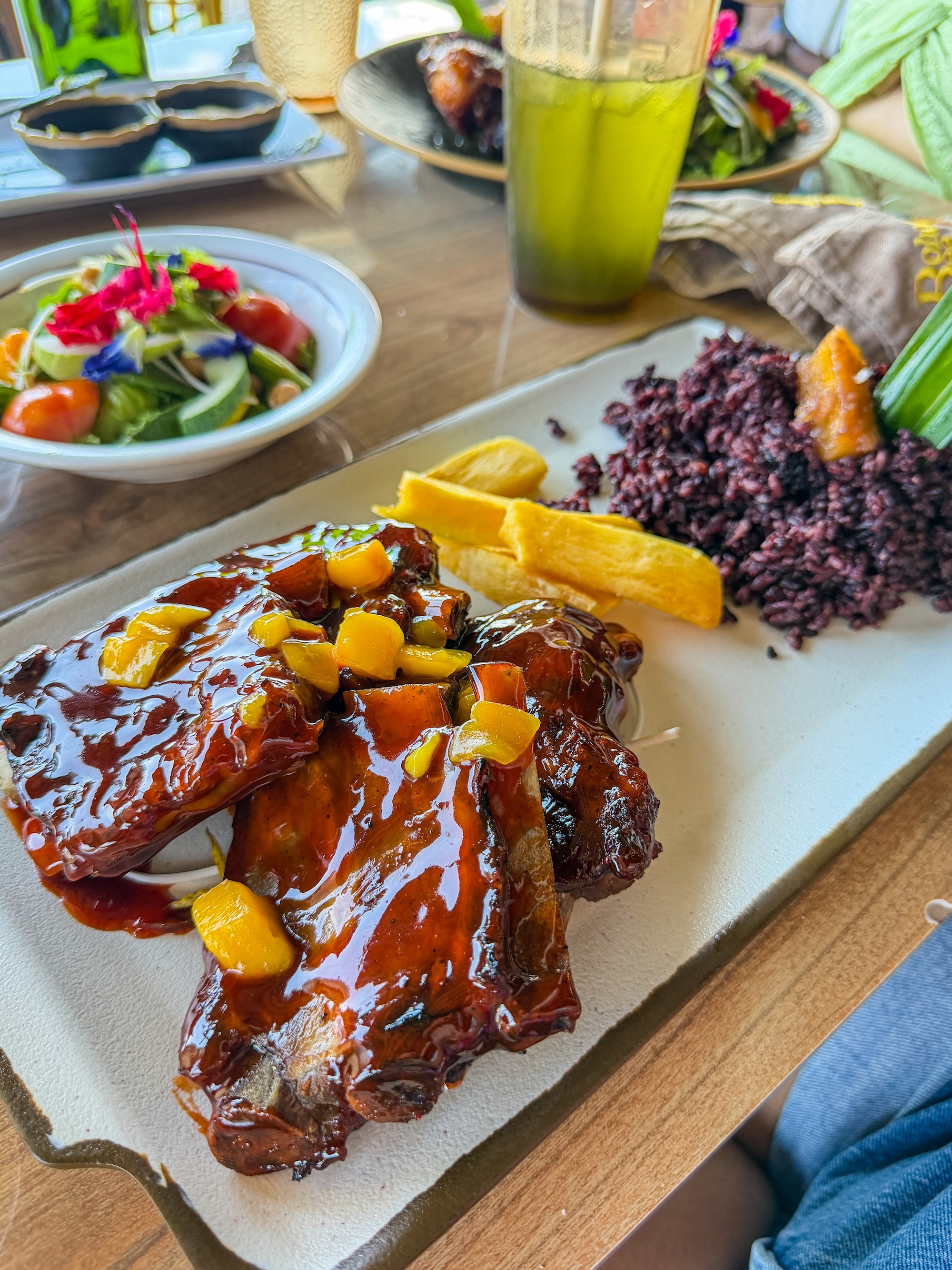 Grilled baby back ribs with mango salsa, cassava fries, and black rice at Bohol Bee Farm restaurant