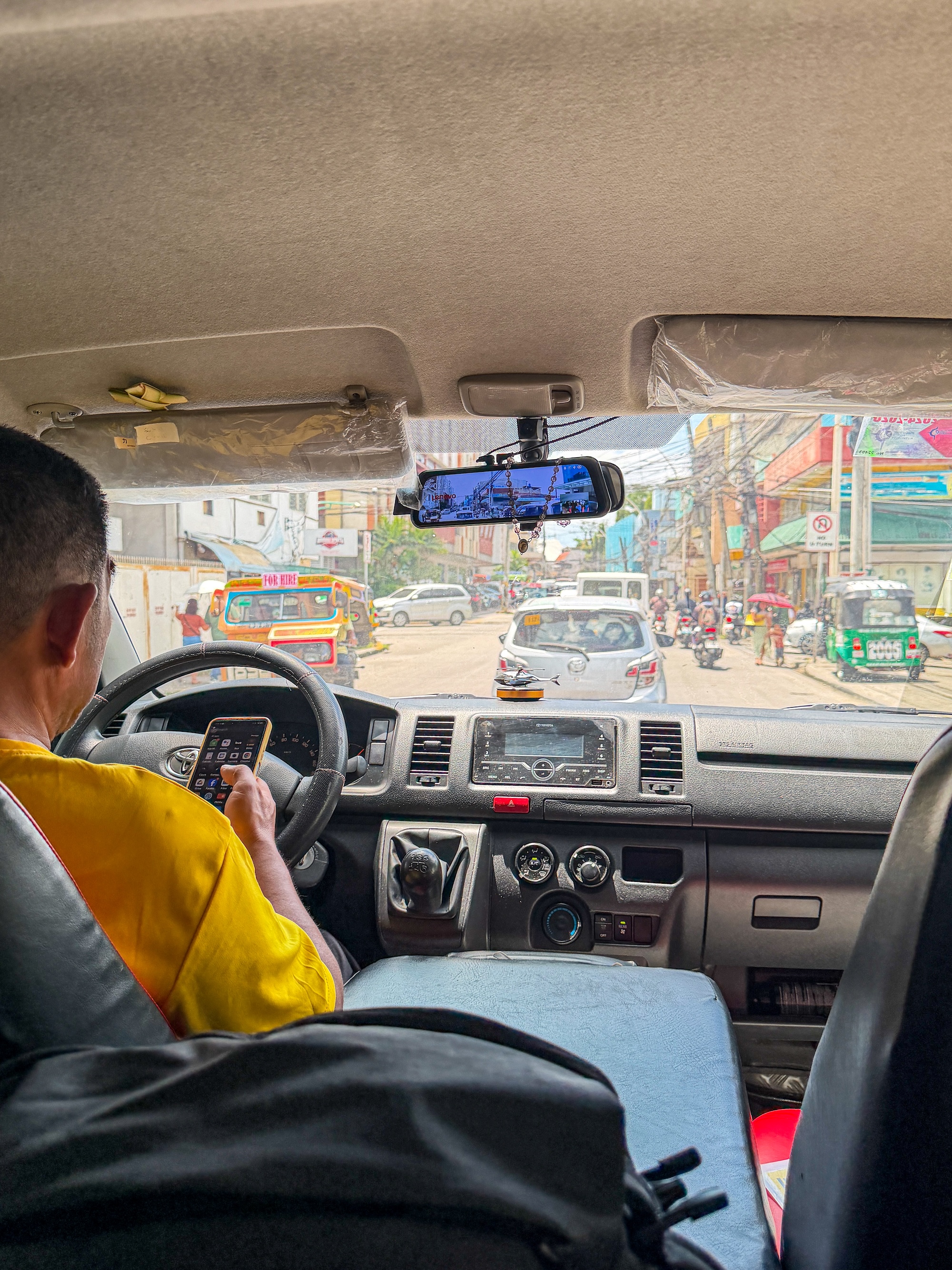 View from inside a van of tricycle and jeepney traffic on the streets near Tagbilaran port
