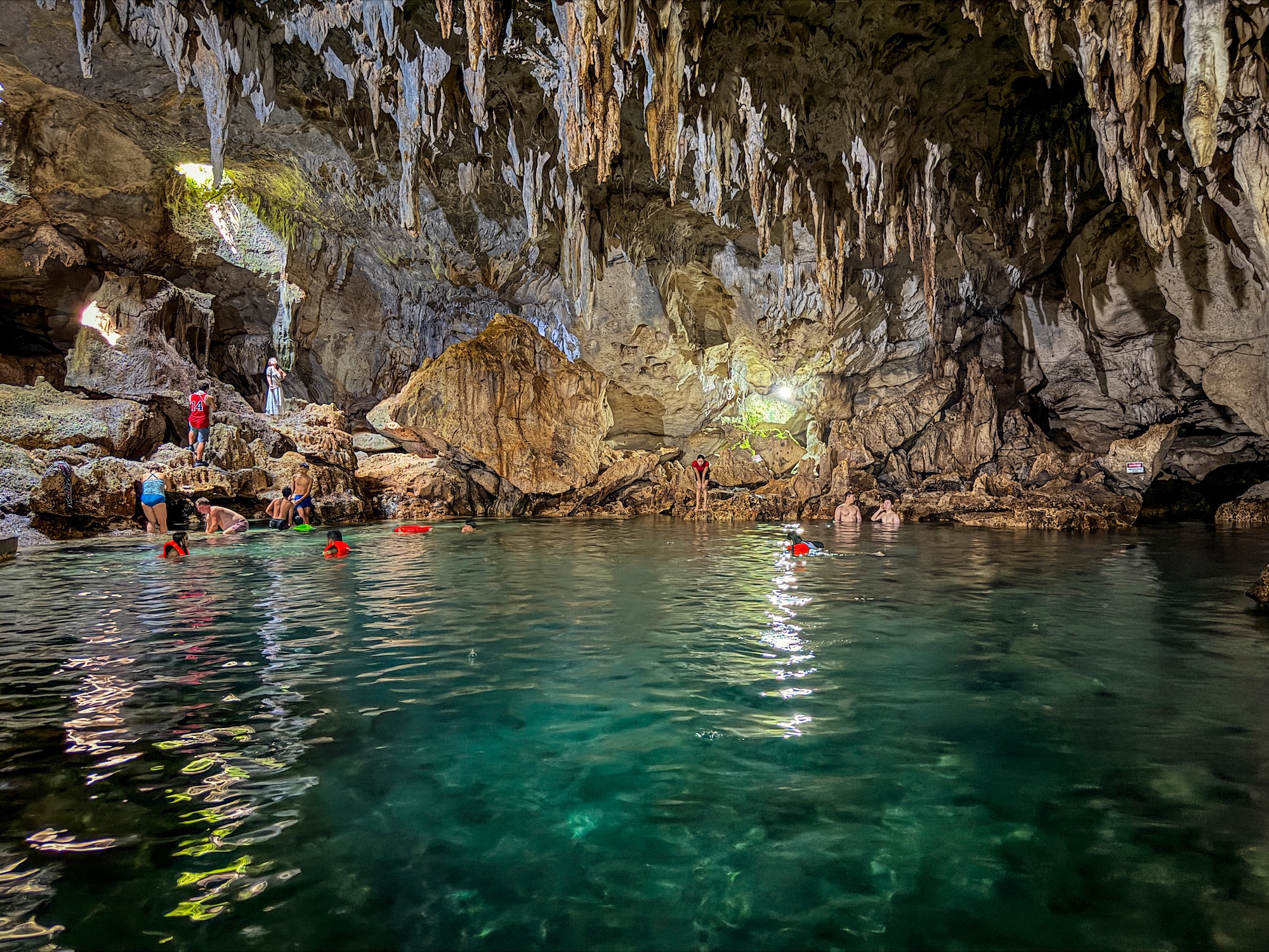 Cave pool with people swimming