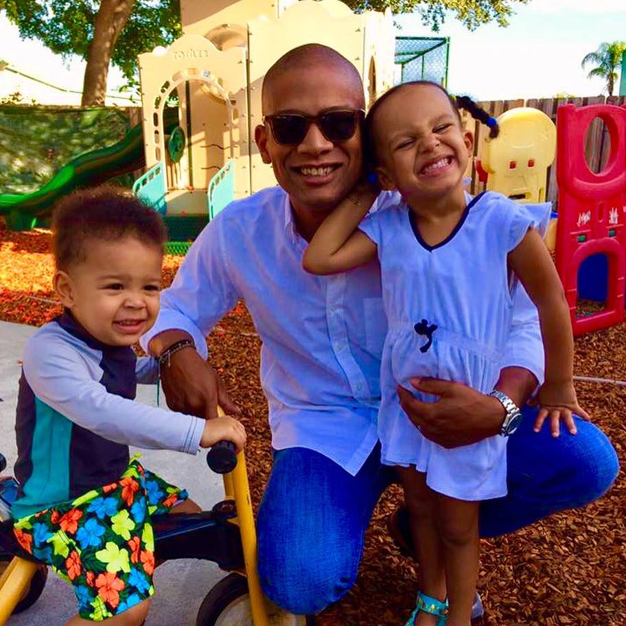 father with children at a children's carousel