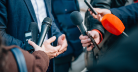 Person being interviewed by journalists