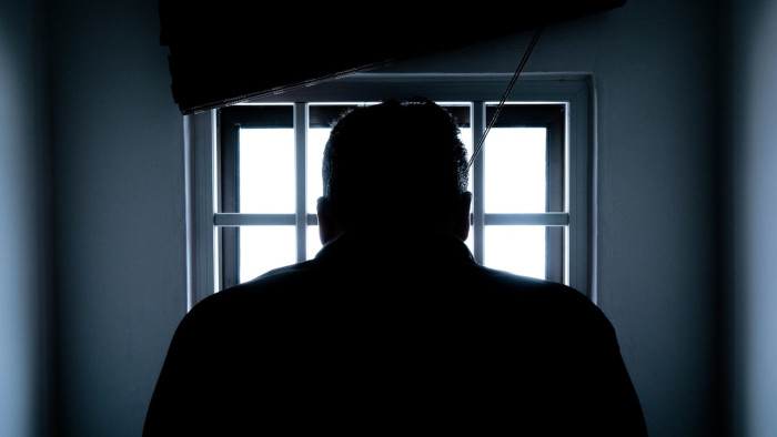 silhouette of a man in a prison cell