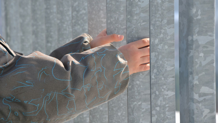 image of a child holding onto metal bars