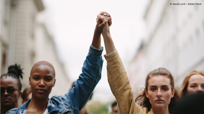 Two women joining hands