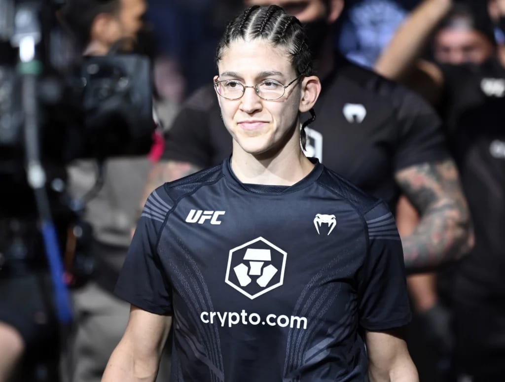 Photo of Roxanne Modafferi walking to the Octagon at UFC 266, dressed in Crypto.com-branded fight kit.