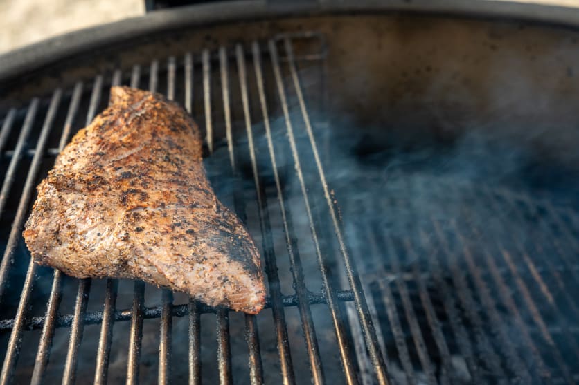 Place the seasoned tri-tip on the cooler side of the grill (indirect heat)