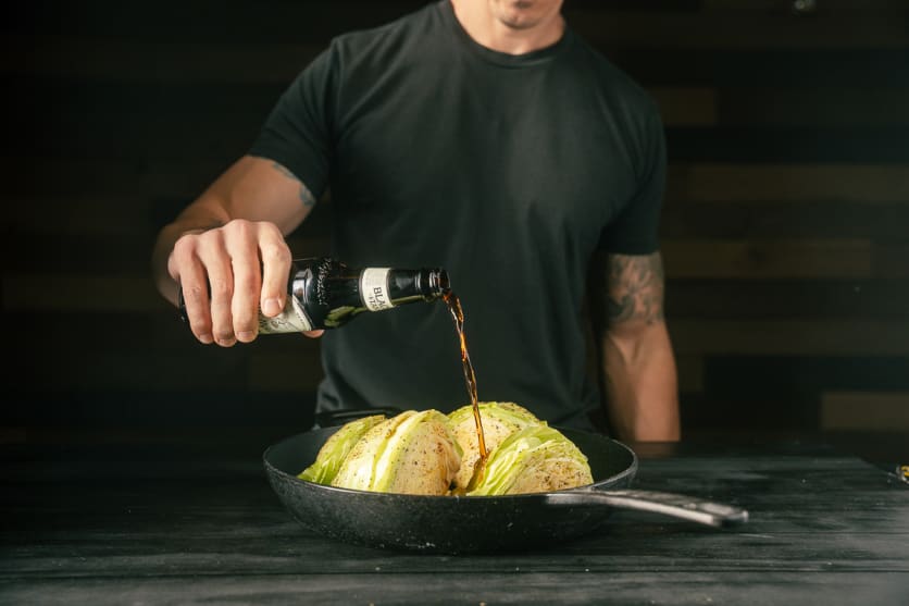 Add beer and cabbage to a cast iron pan