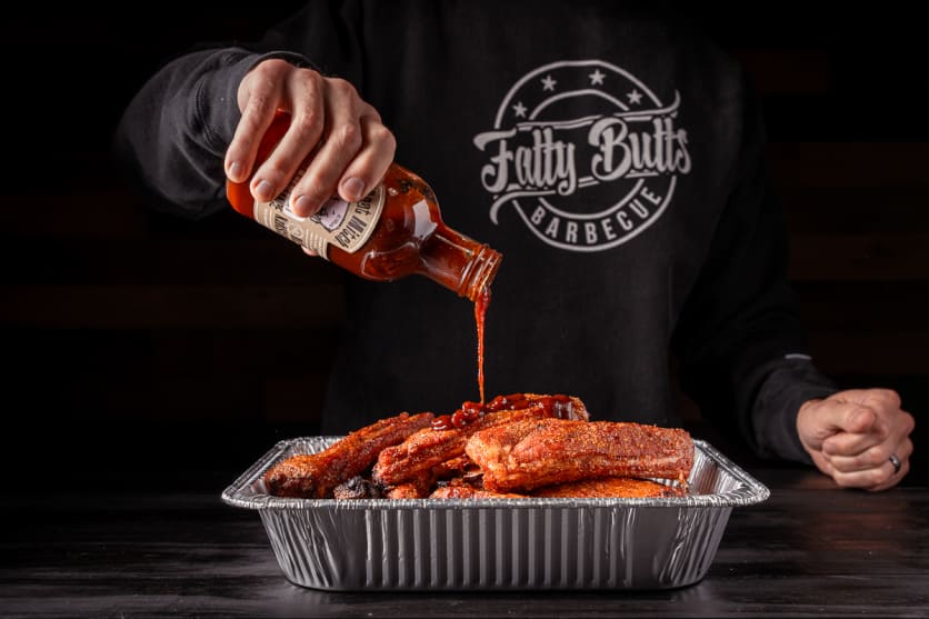 Coat the party ribs in BBQ sauce