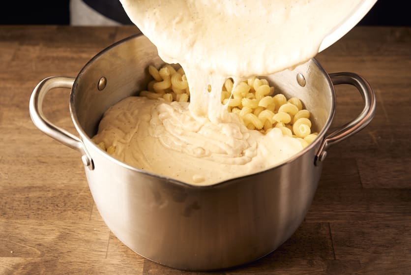 Add cream and cheese sauce to the drained pasta